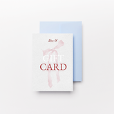 Close-up top view of a pink Gift card on a white background